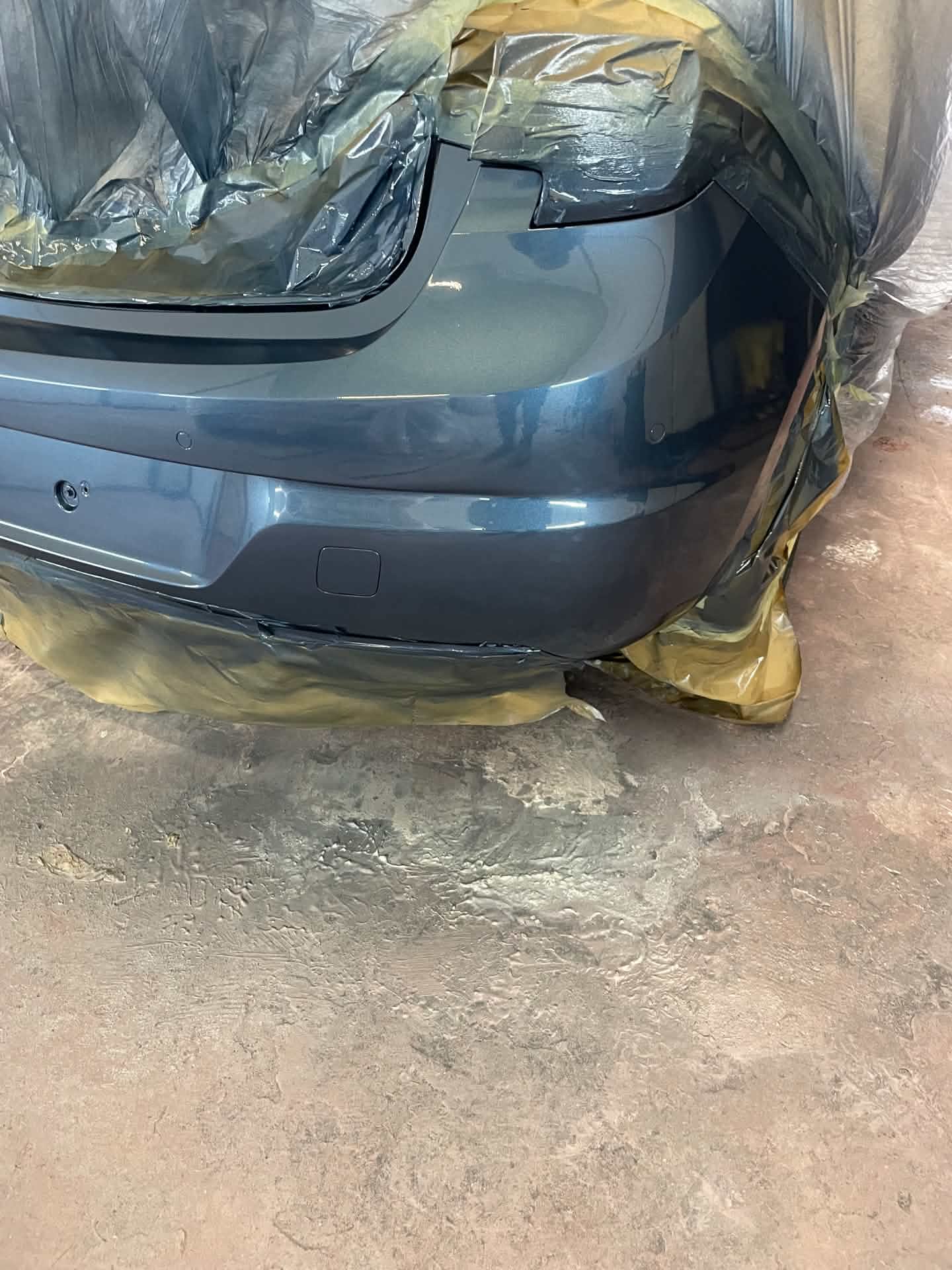 Same car rear bumper after repair, dent and crack fixed