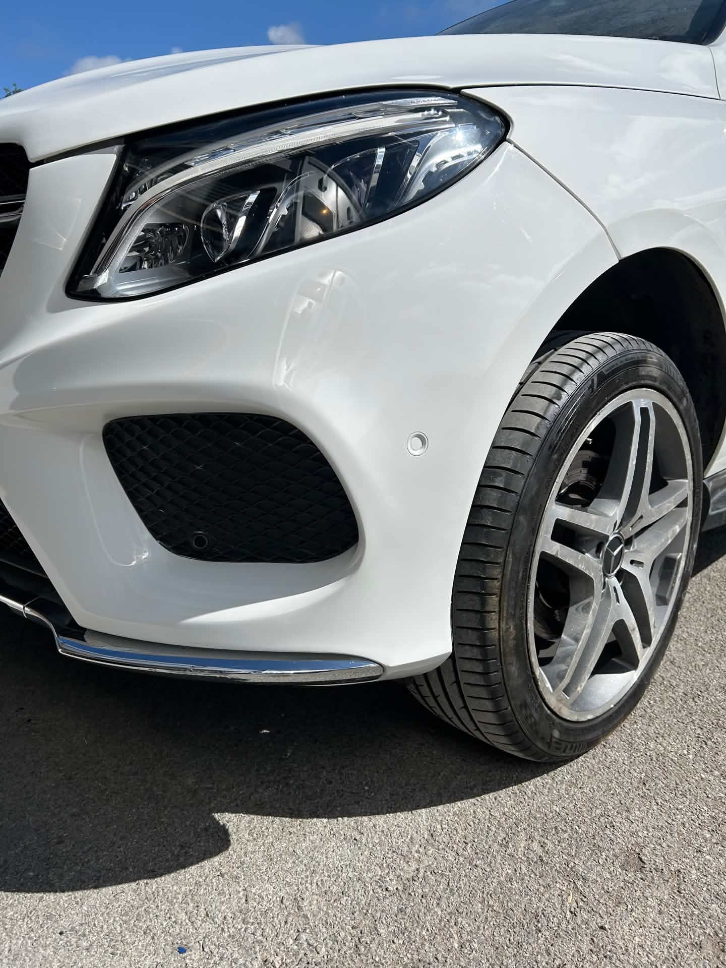 White SUV front bumper after repair, finished