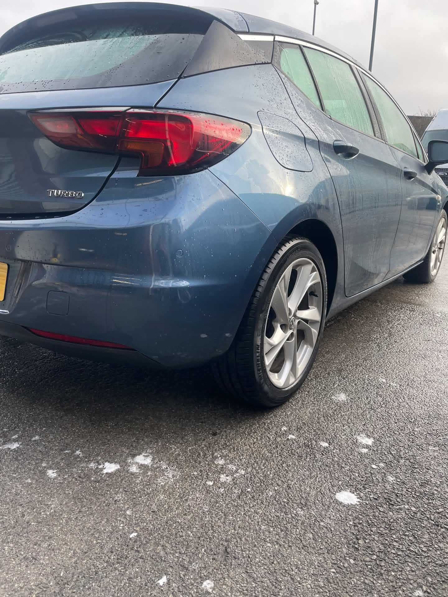 Grey car rear bumper after repair, finished