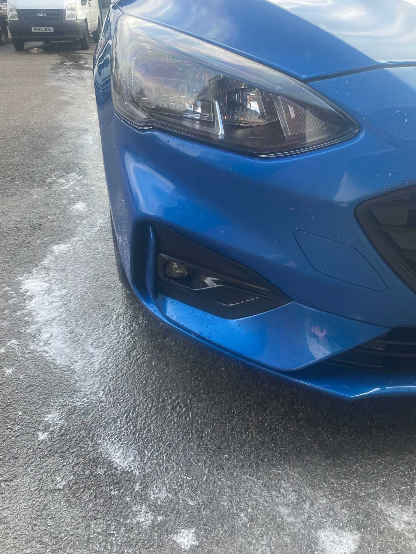 Blue car front bumper after repair, finished